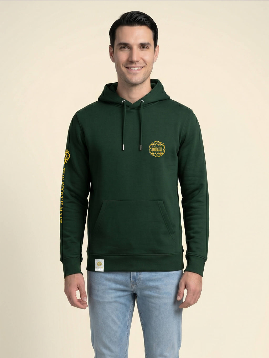 Man wearing a forest green Scottish Malt Whisky Society hoodie with gold logo on the left chest.