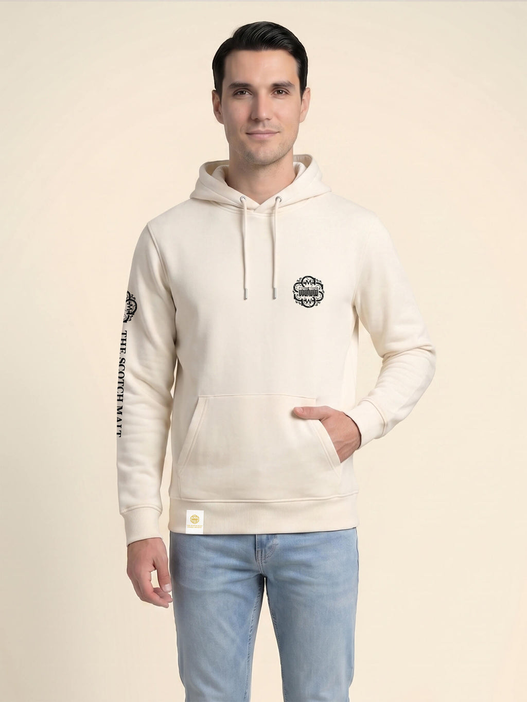 Man wearing an ivory Scottish Malt Whisky Society hoodie with gold logo on the left chest.
