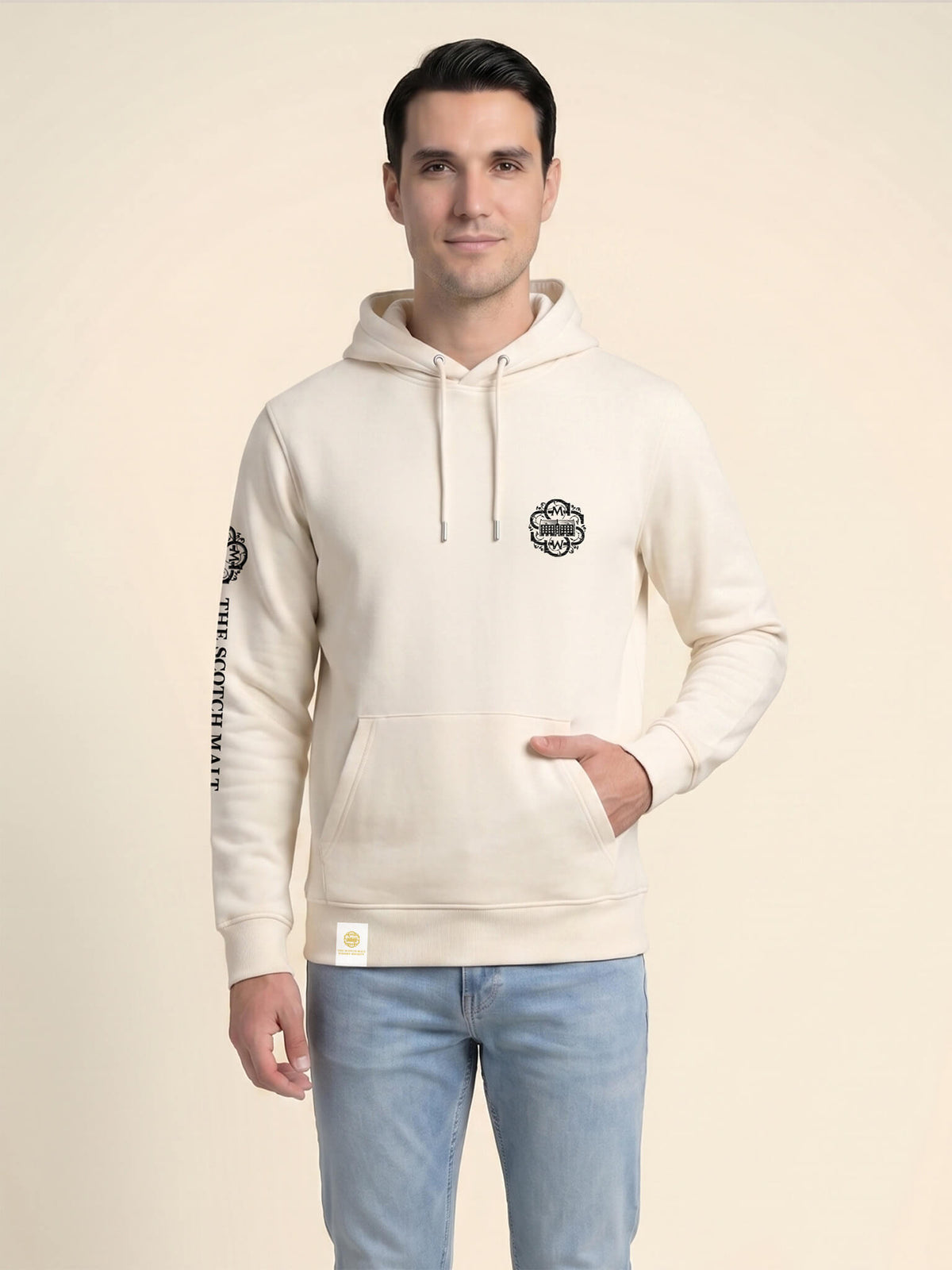 Man wearing an ivory Scottish Malt Whisky Society hoodie with gold logo on the left chest.