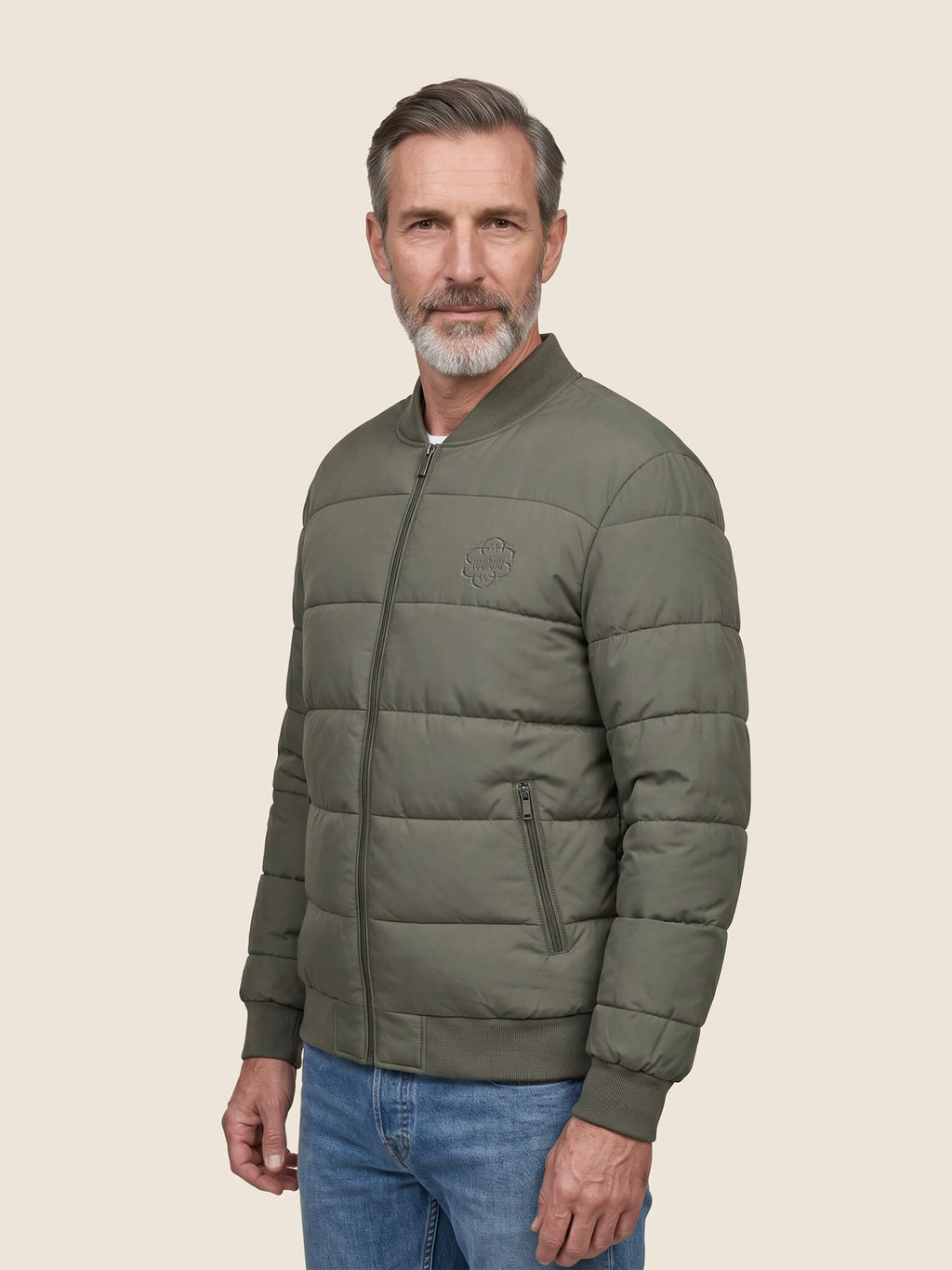 Side view of man wearing a khaki Scottish Malt Whisky Society padded jacket with tone on tone logo on the left chest.