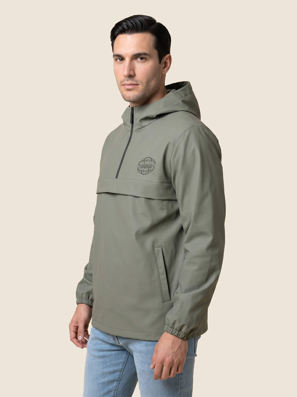 Front view of man wearing a khaki Scottish Malt Whisky Society windbreaker jacket with tone on tone logo on the left chest.