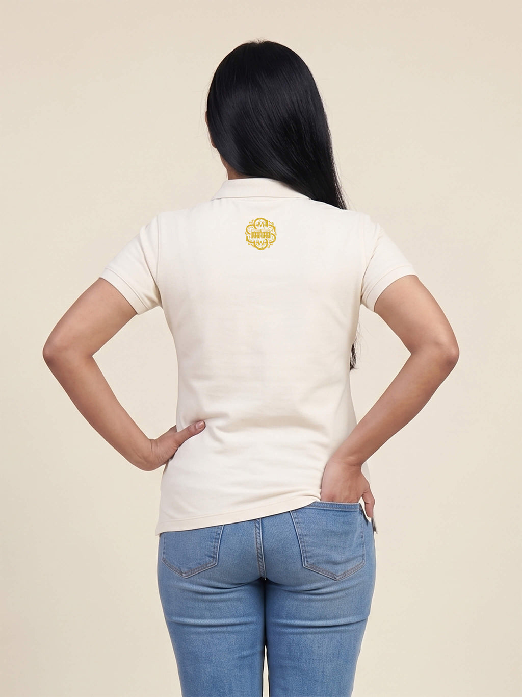 Back view of woman wearing the SMWS Signature Polo T-Shirt with SMWS monogram printed at the back of the neck.