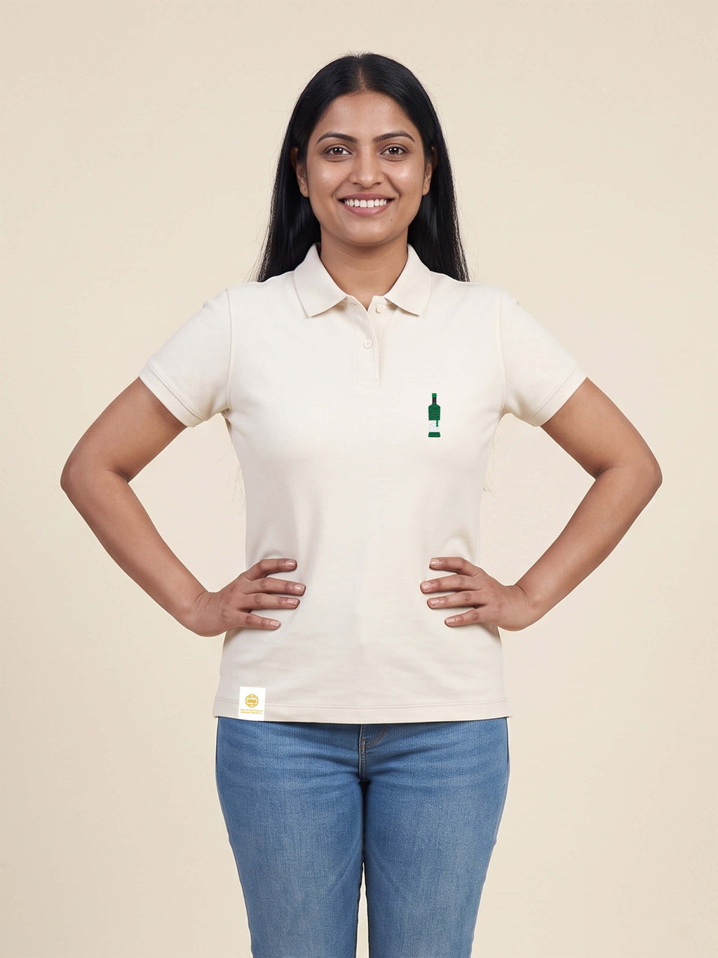 Woman wearing ivory Signature Fitted Polo with bottle printed on left chest matched to your favourite flavour profile