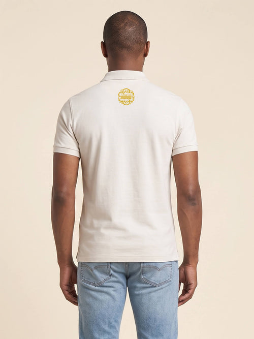 Back view of man wearing ivory Flavour Profile Polo Shirt with SMWS monogram at the back of the neck.