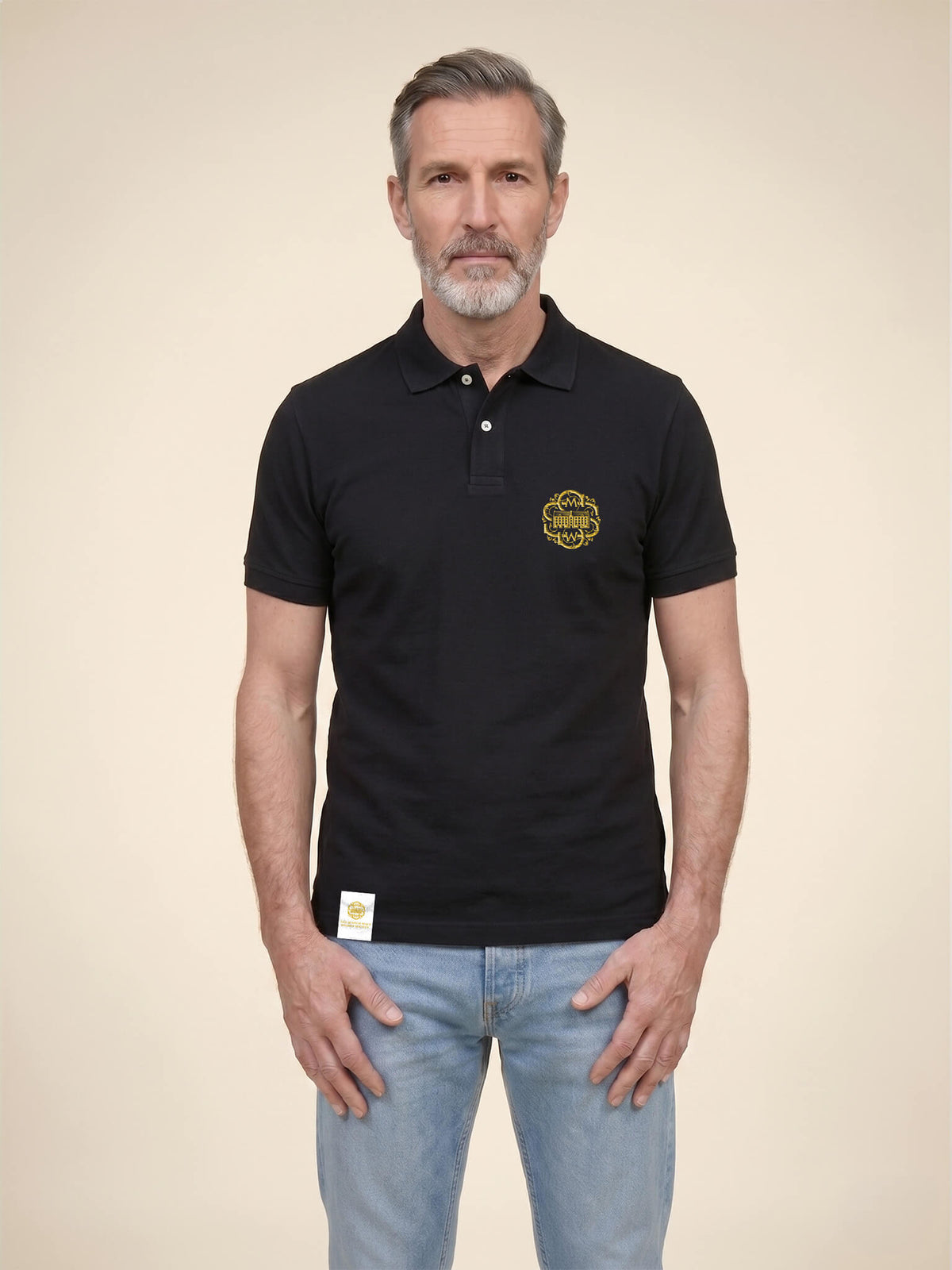 Man wearing a black Scottish Malt Whisky Society polo shirt with gold logo on the left chest.