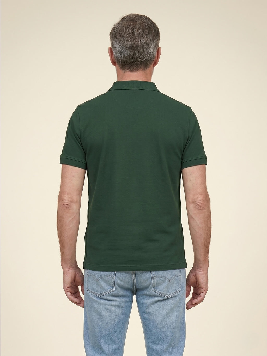 Back view of man wearing a black Scottish Malt Whisky Society polo shirt.