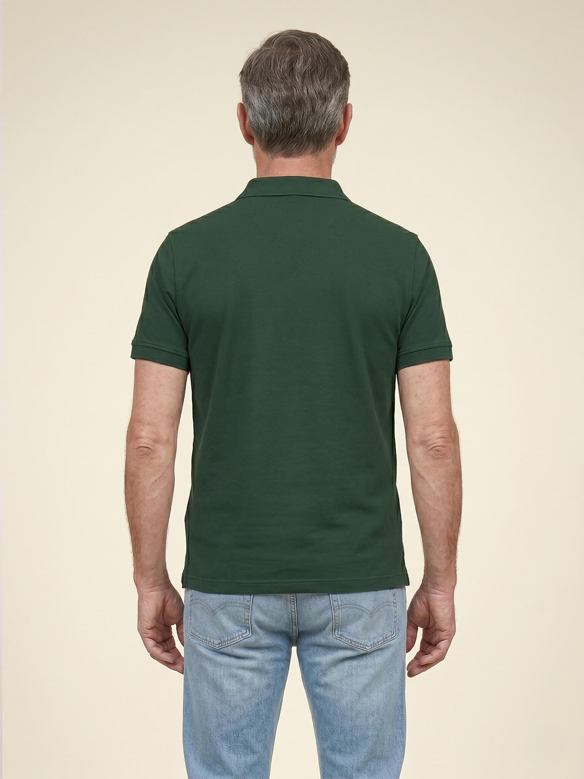 Back view of man wearing a black Scottish Malt Whisky Society polo shirt.