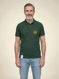 Man wearing a forest green Scottish Malt Whisky Society polo shirt with gold logo on the left chest.