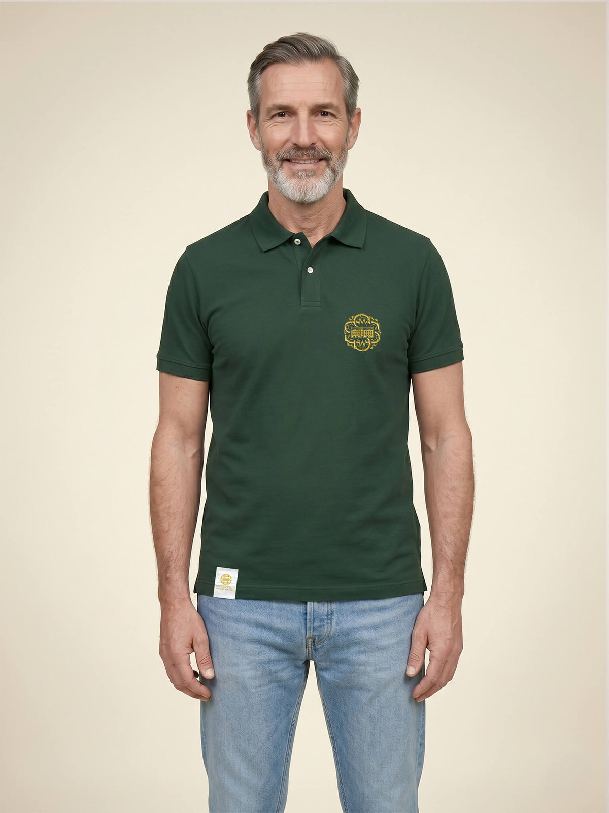 Man wearing a forest green Scottish Malt Whisky Society polo shirt with gold logo on the left chest.