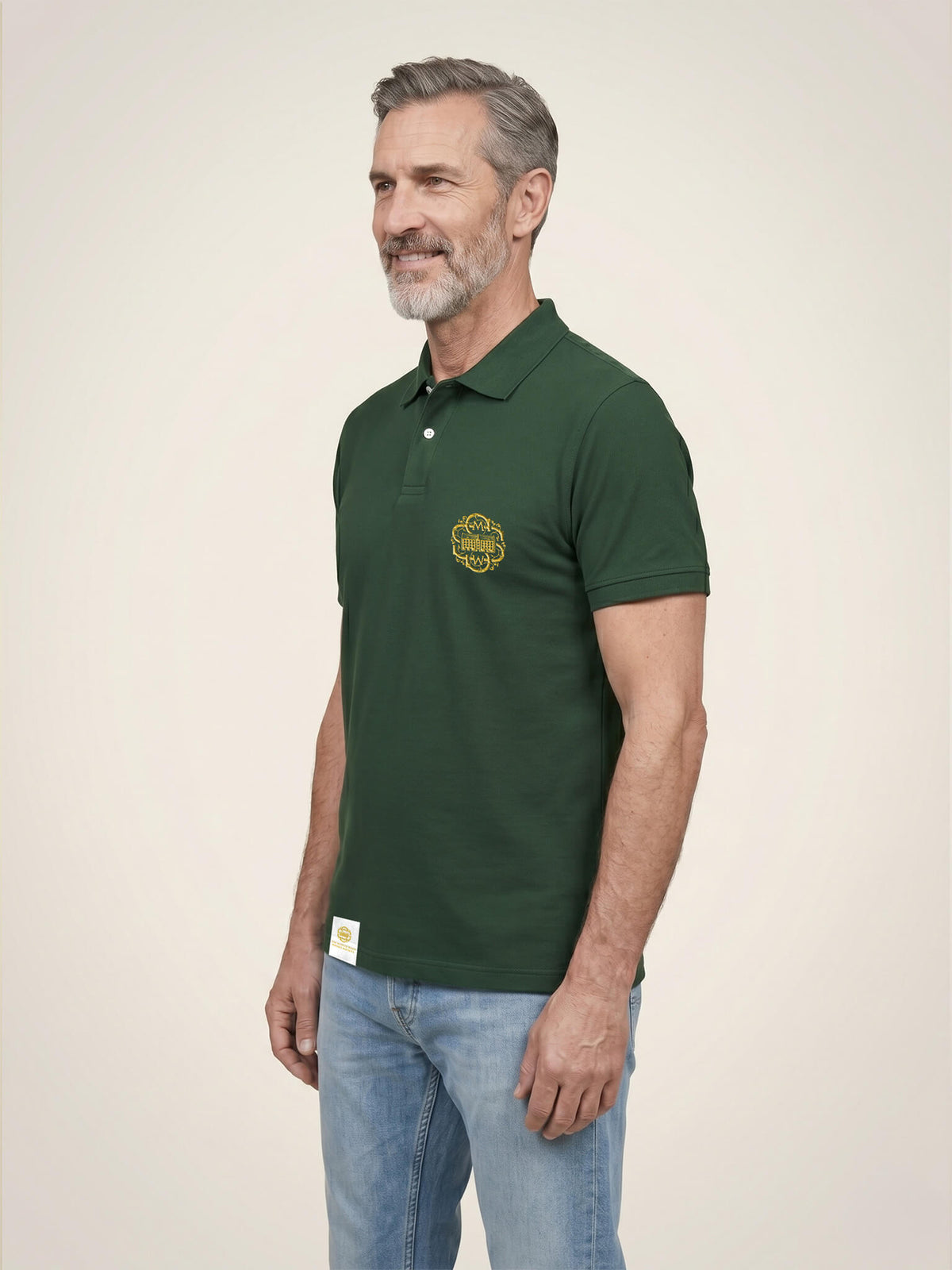 Side view of man wearing a black Scottish Malt Whisky Society polo shirt with gold logo on the left chest.