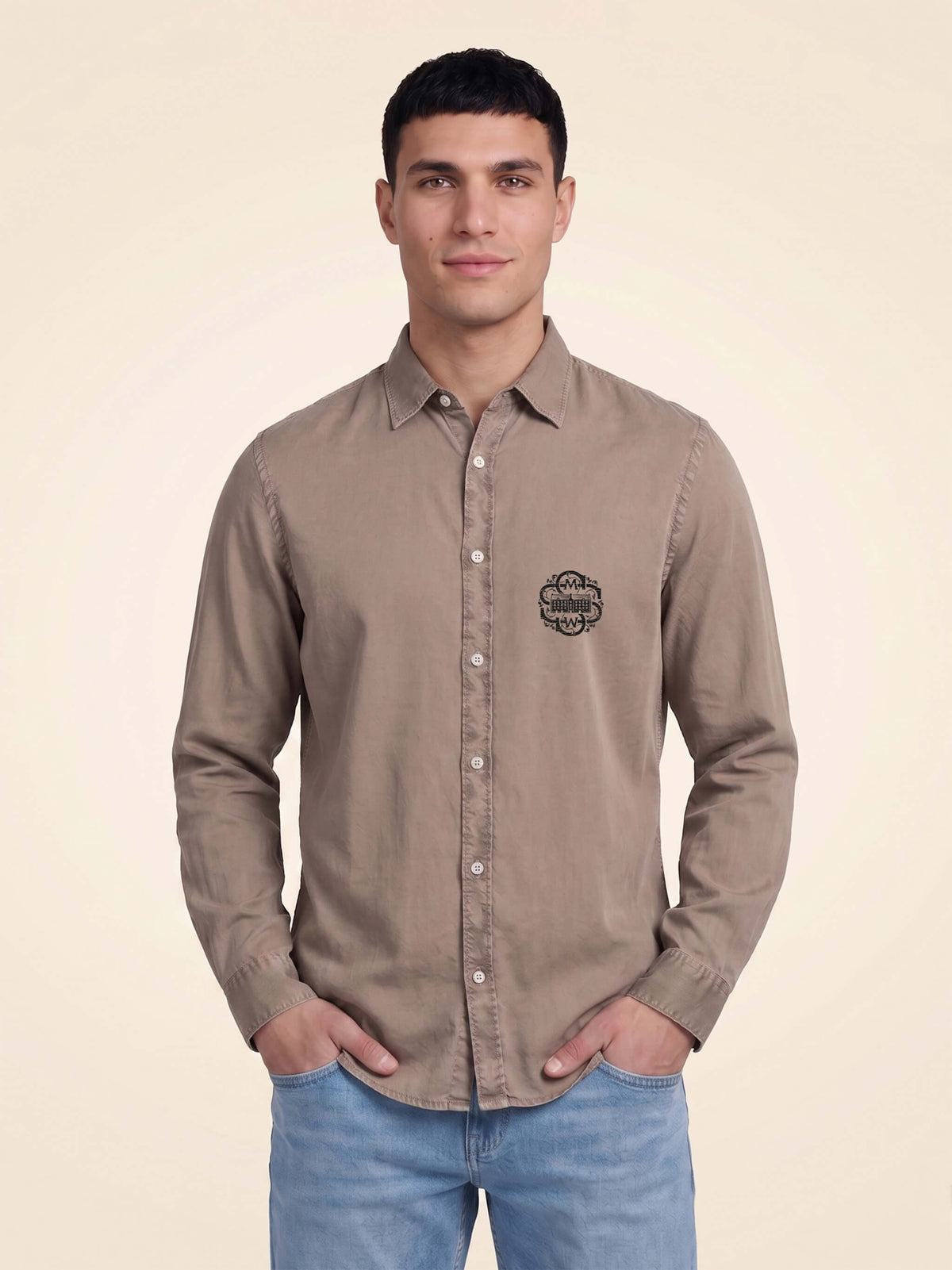 Man wearing a washed linen organic cotton shirt with SMWS logo mark on left chest.