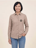 Woman wearing a washed linen Scottish Malt Whisky Society organic shirt with logo on the left chest. Can be personalised with your name on the right chest.