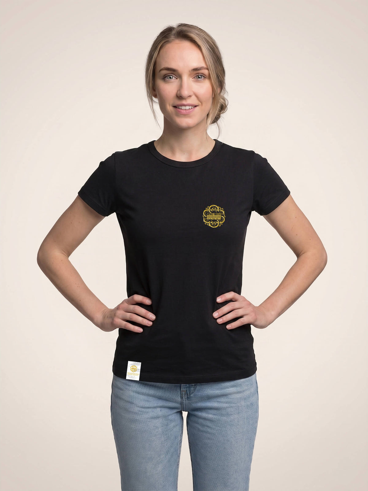 Woman wearing a black Scottish Malt Whisky Society t-shirt with gold logo on the left chest.
